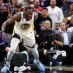 Draymond Green de los Golden State Warriors pasa por encima de Domantas Sabonis