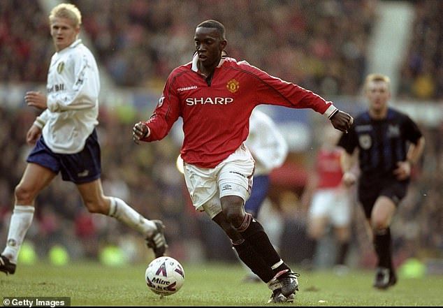 El exdelantero del Manchester United Dwight Yorke (centro) cree que la temporada de tripletes de su equipo en 1999 merece más crédito