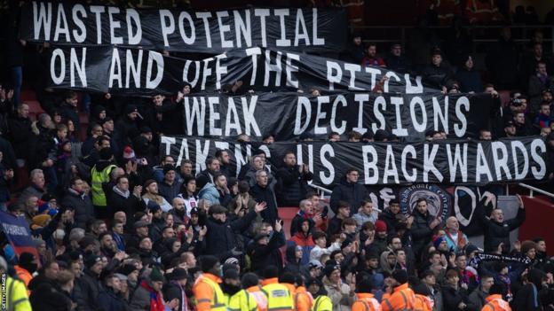 Una pancarta de protesta de los fanáticos del Crystal Palace que dice "Potencial desperdiciado dentro y fuera de la cancha.  Decisiones débiles que nos llevan hacia atrás".