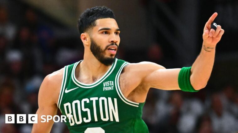 Boston Celtics star Jayson Tatum celebrates hitting a basket