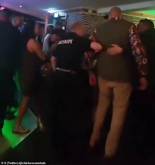 Tyson Fury (chaqueta verde) tuvo que ser escoltado fuera de un bar el fin de semana y luego se desplomó en la acera.