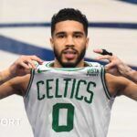 Jayson Tatum brandishes his jersey in celebration