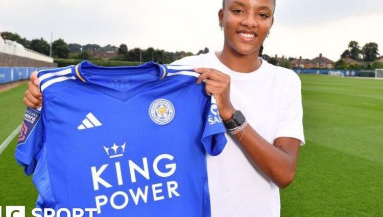 Shana Chossenotte holding up her Leicester shirt