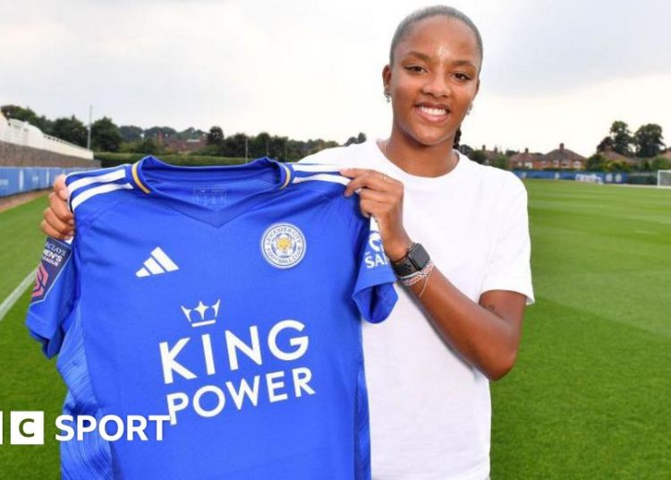 Shana Chossenotte holding up her Leicester shirt