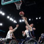 Steve Serio of the United States shoots at the basket while Gregg Warburton tries to intercept during the Paralympic wheelchair basketball gold-medal match