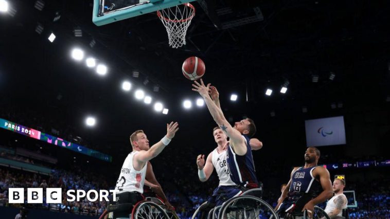 Steve Serio of the United States shoots at the basket while Gregg Warburton tries to intercept during the Paralympic wheelchair basketball gold-medal match