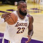 LeBron James holds the basketball in his right hand while playing for the LA Lakers