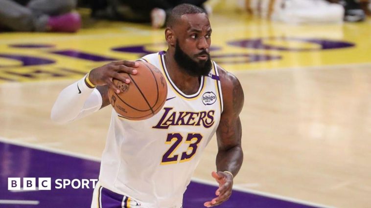 LeBron James holds the basketball in his right hand while playing for the LA Lakers