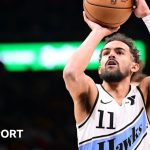 The Atlanta Hawks' Trae Young lines up a three-point shot