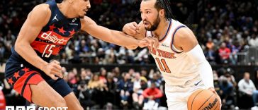 Jalen Brunson of the New York Knicks handles the ball against Malcolm Brogdon of the Washington Wizards