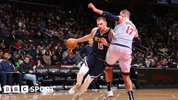 Nikola Jokic dribbles with the ball