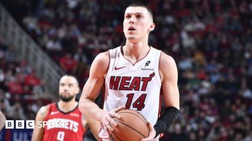 Tyler Herro holding a basketball