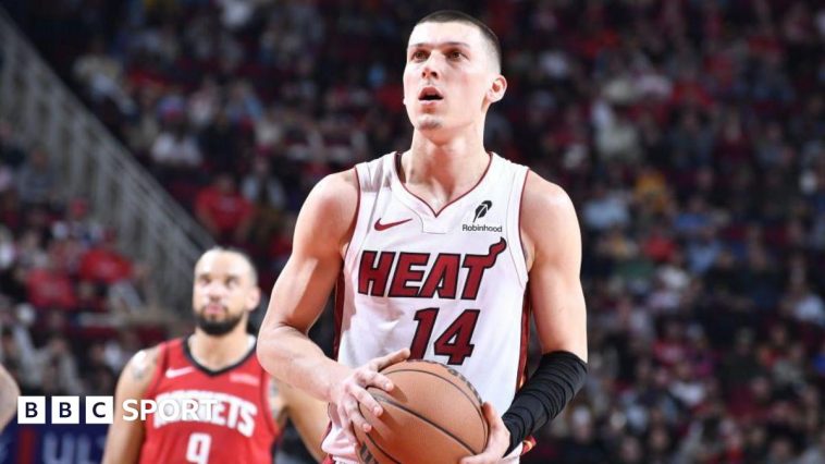 Tyler Herro holding a basketball