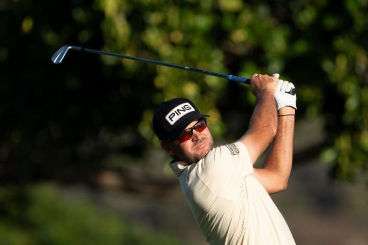 Corey Conners golpea su tiro de salida en el hoyo 11 durante la segunda ronda del torneo de golf Sony Open en Waialae Country Club.