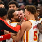 Trae Young being mobbed by his Atlanta Hawks team-mates after scoring his late game-winning three-pointer