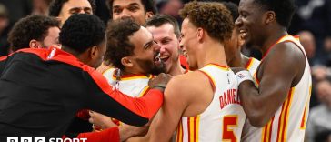 Trae Young being mobbed by his Atlanta Hawks team-mates after scoring his late game-winning three-pointer