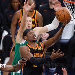 Shai Gilgeous-Alexander shooting a basket above three Boston players