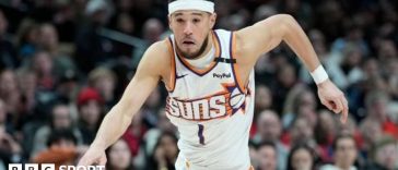 Devin Booker preparing to throw his three-pointer than broke the Phoenix Suns' scoring record.