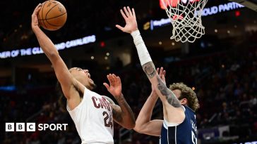 Cleveland Cavaliers forward Jaylon Tyson drives to the basket against Dallas Mavericks center Kylor Kelley