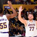 Luka Doncic high-fiving team-mate Trey Jemison III