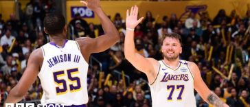 Luka Doncic high-fiving team-mate Trey Jemison III